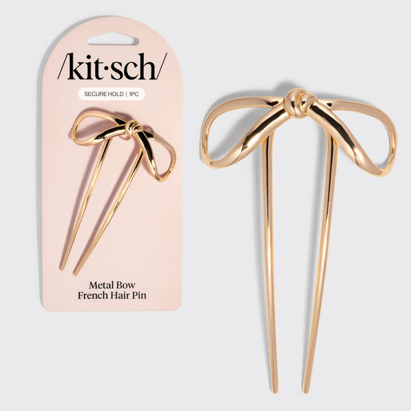 A Kit-Sch metal bow French hair pin shown next to its light pink retail packaging card on a light gray background.
