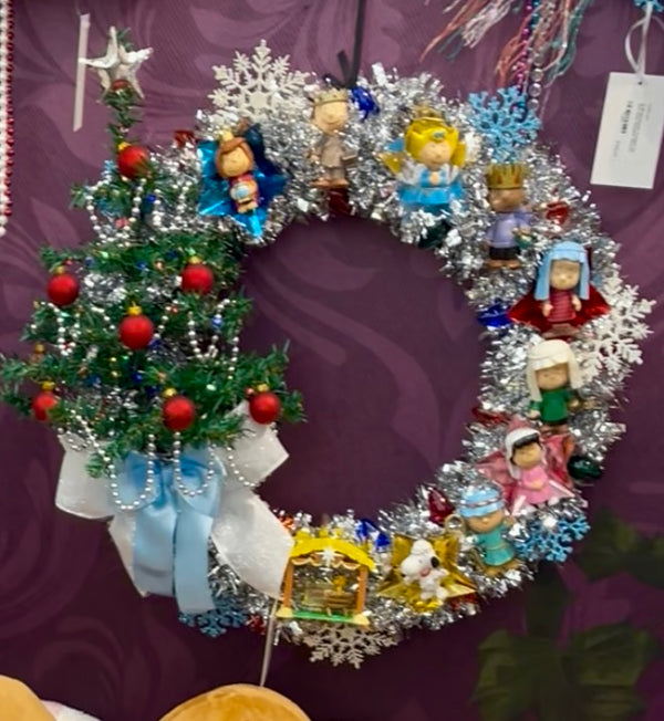 Decorative Christmas wreath with small figurines and ornaments on a purple  background Charlie Brown Christmas inspired handmade wreath 